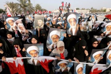 Anti-government protesters hold posters of Shi'ite cleric Ayatollah Sheikh Isa Qassim during an anti-government protest organised by Bahrain's main opposition group Al Wefaq, in Budaiya, west of Manama, Bahrain May 17, 2013. REUTERS/Hamad I Mohammed/File Photo