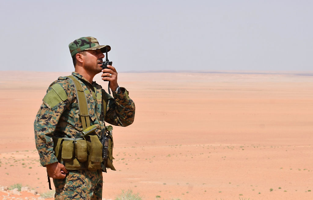A member of the Syrian government forces talks on a walkie-talkie in Bir Qabaqib, more than 40 kilometres west of Deir Ezzor, after taking control of the area on their way to Kobajjep in the ongoing battle against Islamic State (IS) group jihadists on September 4, 2017.
Syria's army are fighting the Islamic State group on the edges of Deir Ezzor seeking to break the siege of a government enclave and oust the jihadists from a key stronghold. / AFP PHOTO / George OURFALIAN        (Photo credit should read GEORGE OURFALIAN/AFP via Getty Images)