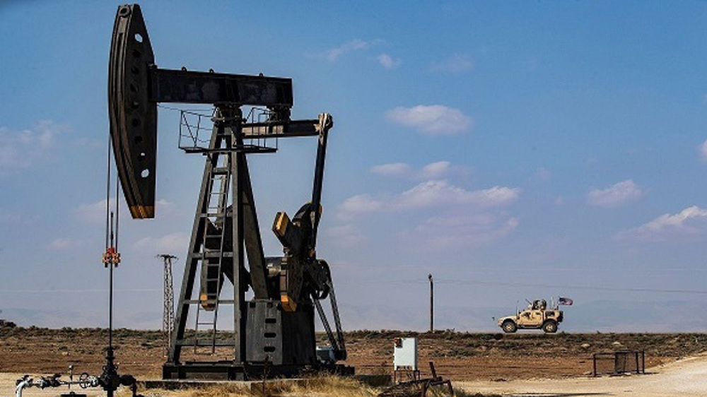 Vehículo estadounidense pasa cerca de un poco de petróleo en Siria