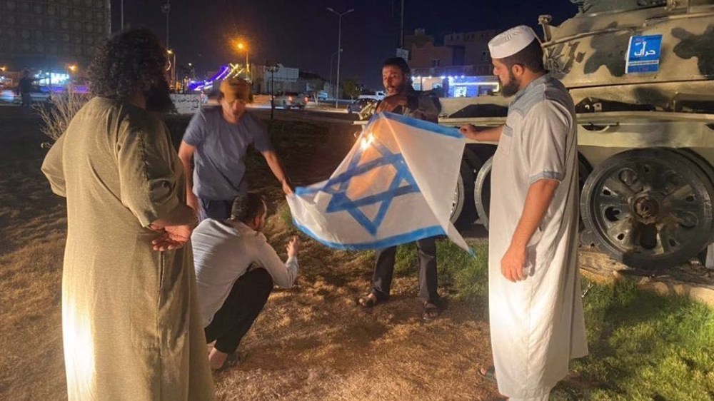Un grupo de libios quema una bandera israelí